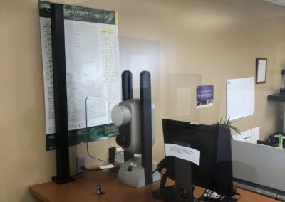 Office multi-desk barrier installation with cutout pass-through